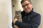 Sir Robert Buckland MP pictured with his rescue cat Mrs Landingham