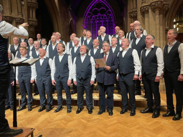 Robert Buckland MP pictured with the Wessex Choir Performing at The High Sheriff of Wiltshire’s Annual Charity Concert in aid of Rotary Swindon Cares